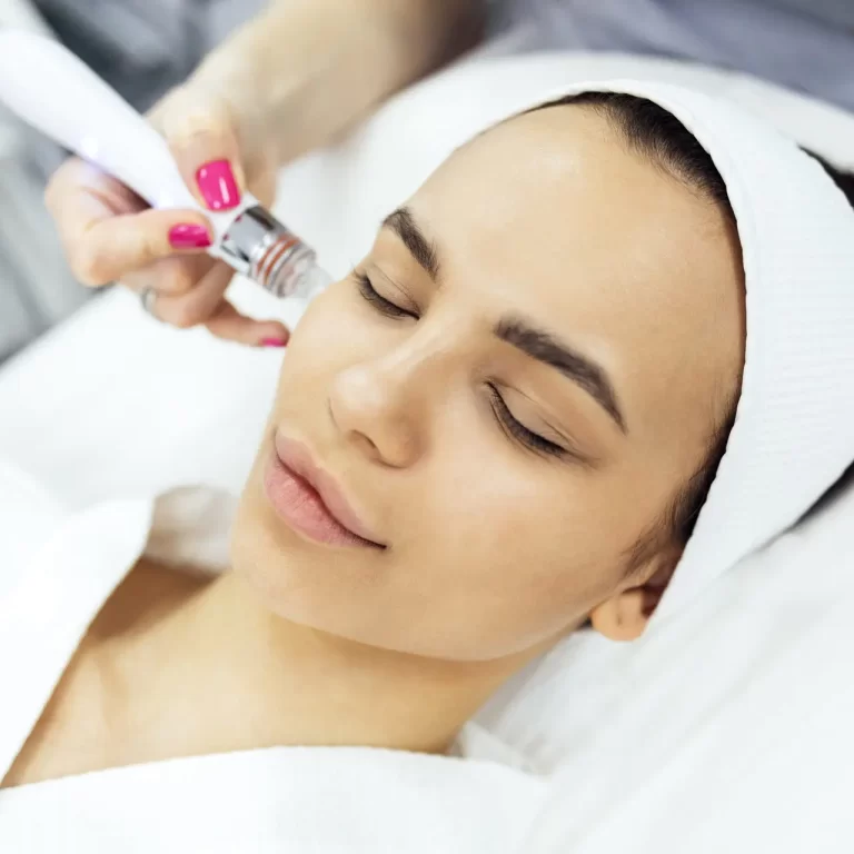 Brunette young woman undergoes a procedure of vitamin peeling in beauty salon, a unique and innovative triplex product it removes impurities by means of starch microspheres